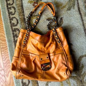 Orange Hobo style bag. 15 inches length, straps add 10 inches , 12 inches wide.